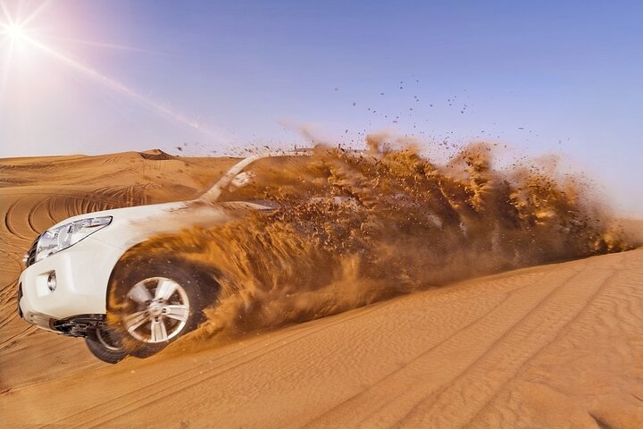Experience the rush of driving through stunning dunes where luxury meets adventure. Enjoy free sandboarding and expert guidance for an unforgettable journey across Dubai's majestic desert landscapes.